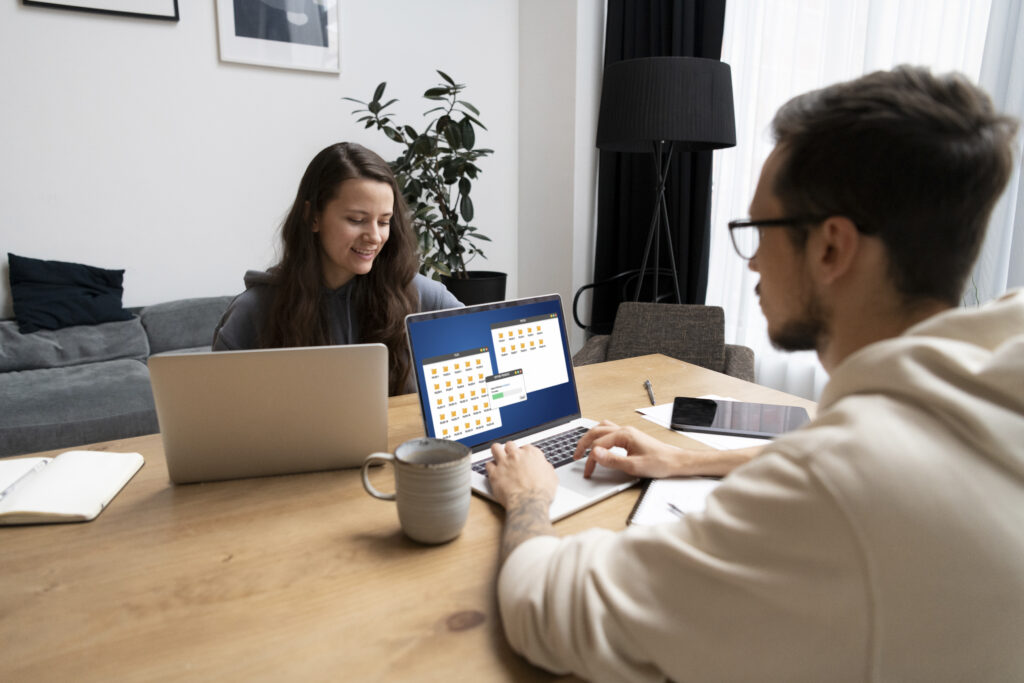 a man and a woman working together on their laptops