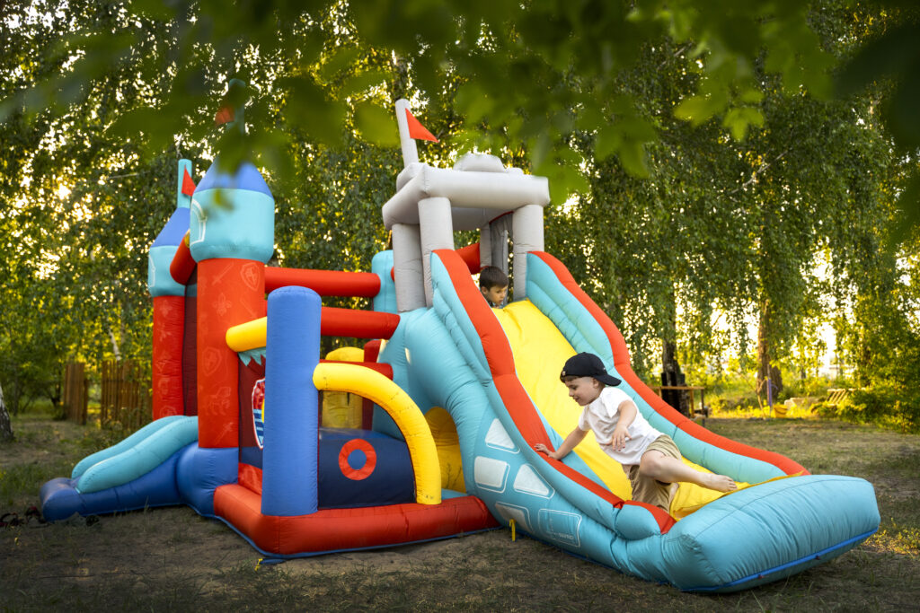 chlidren playing in an inflatable bouncy house