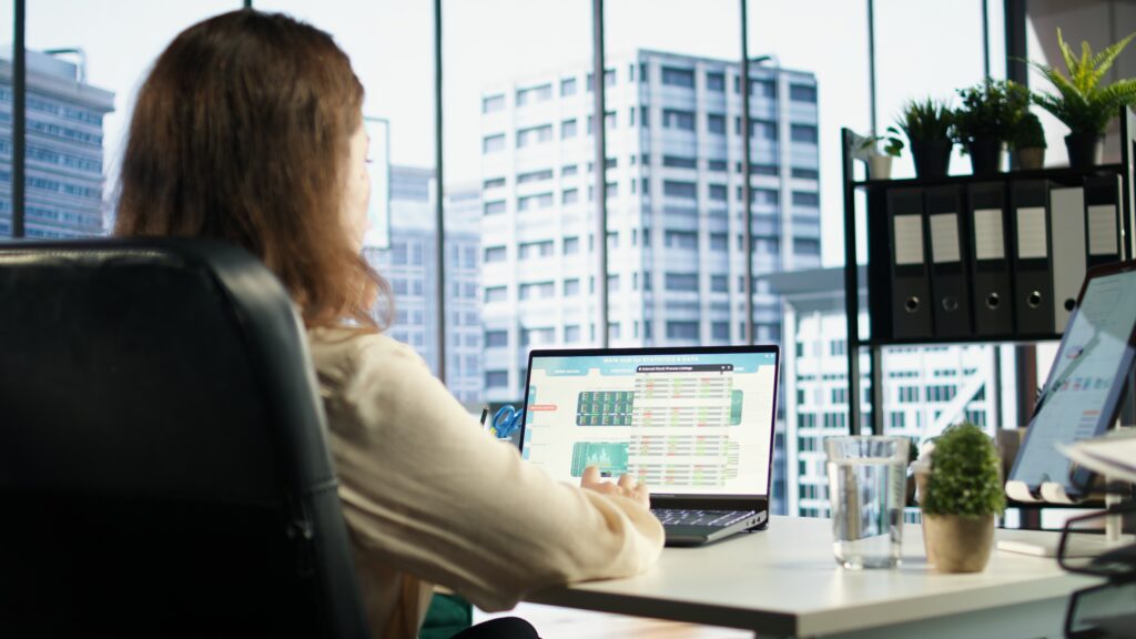 woman in an office working on a laptop