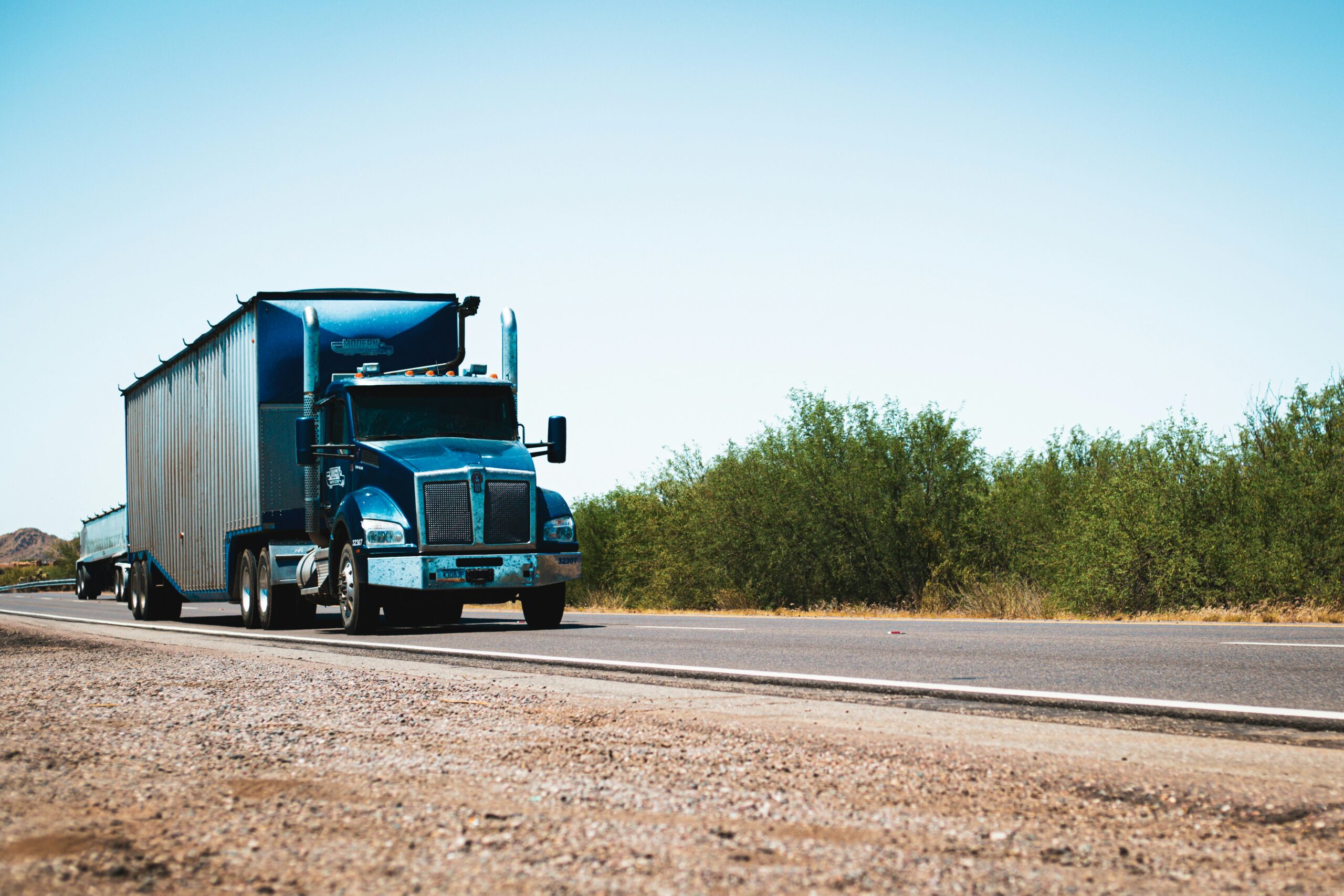 Blue semi-truck on open road