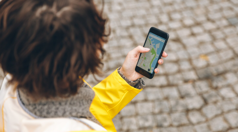 Boy using his phone with maps