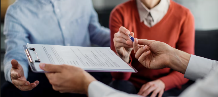 Customers discussing an insurance policy for a rental business