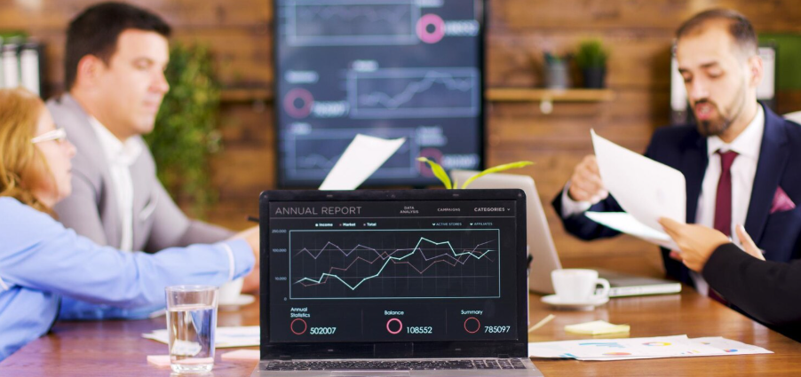 Employers discussing pricing strategies with a laptop present