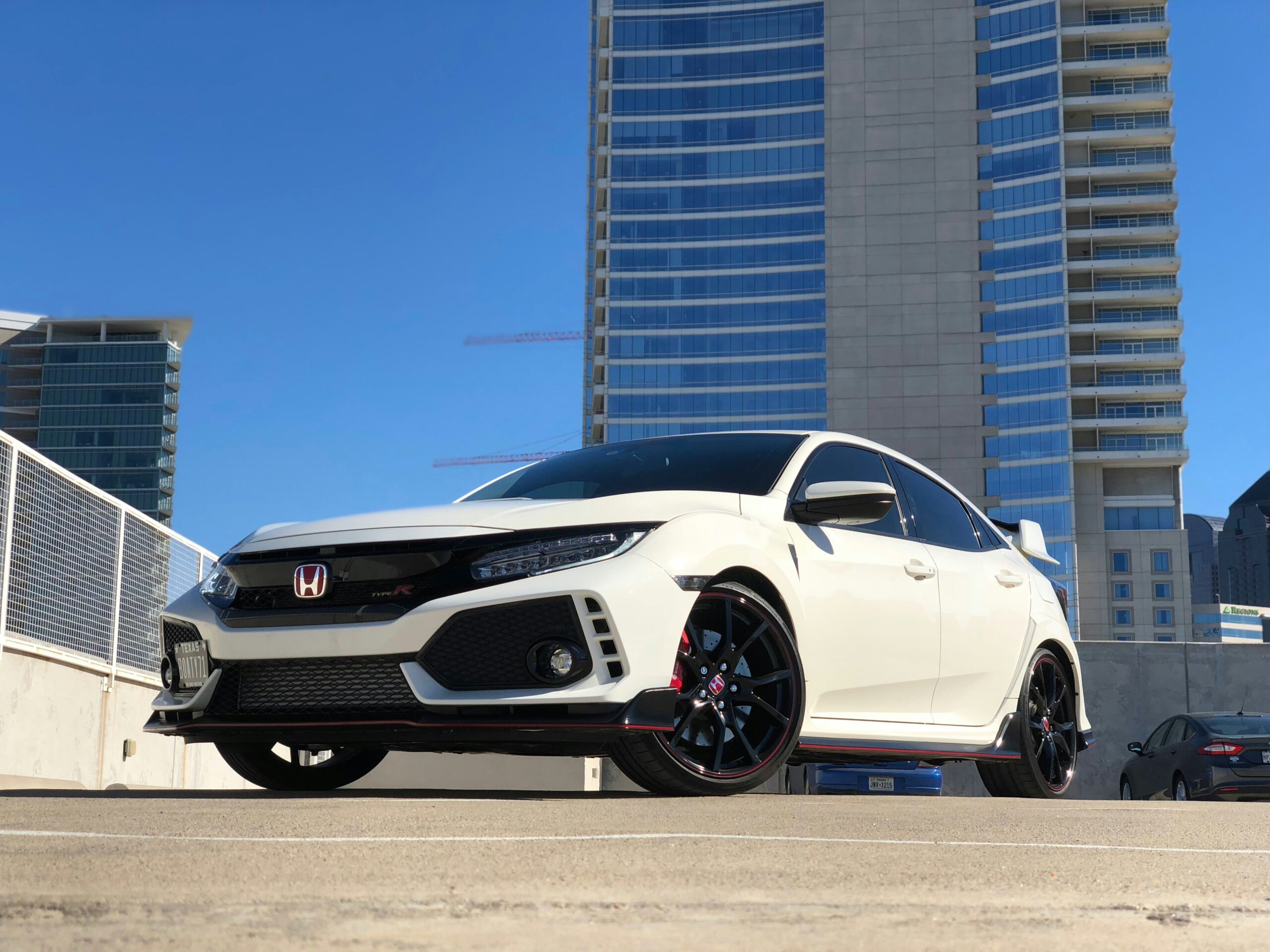 White Honda Civic Type R in a city parking lot