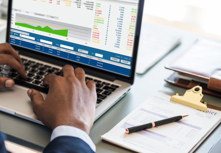 Man working with asset management on a laptop
