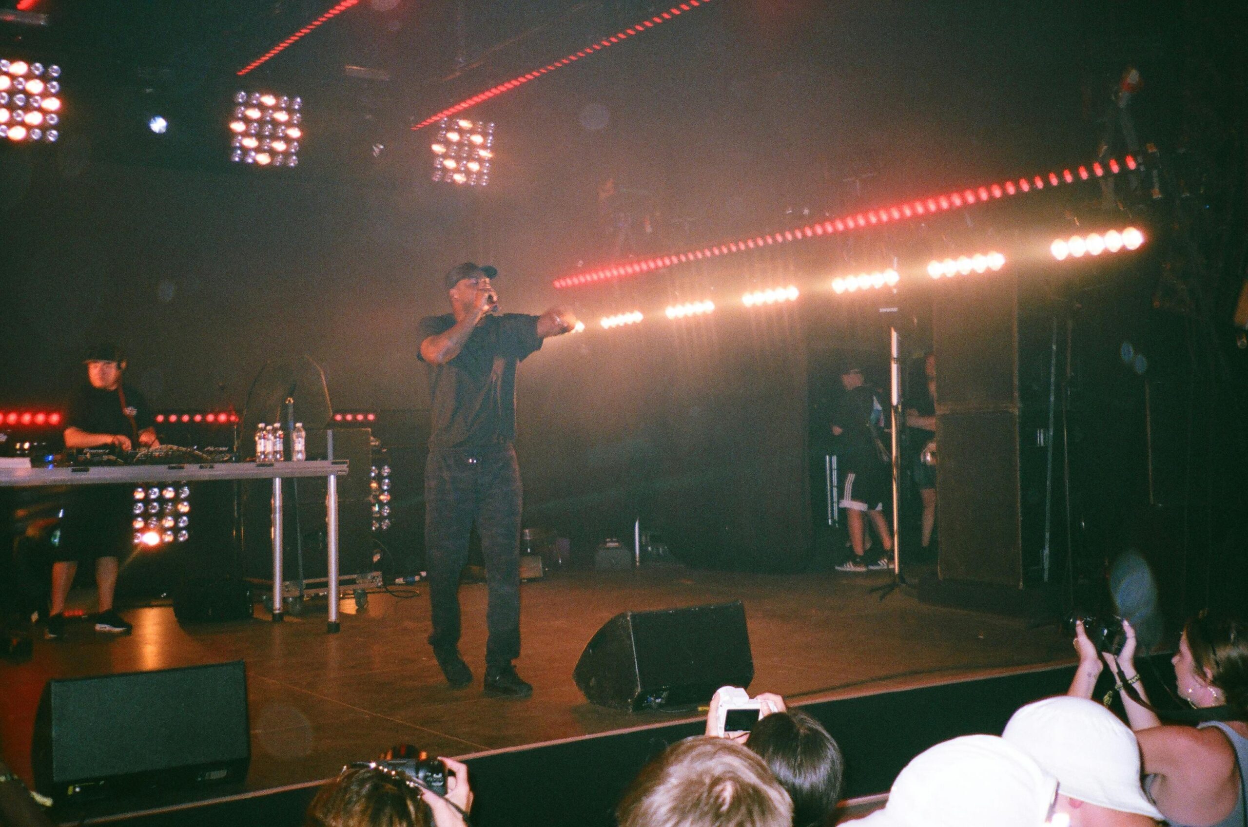 Musician performing on stage with red concert lights