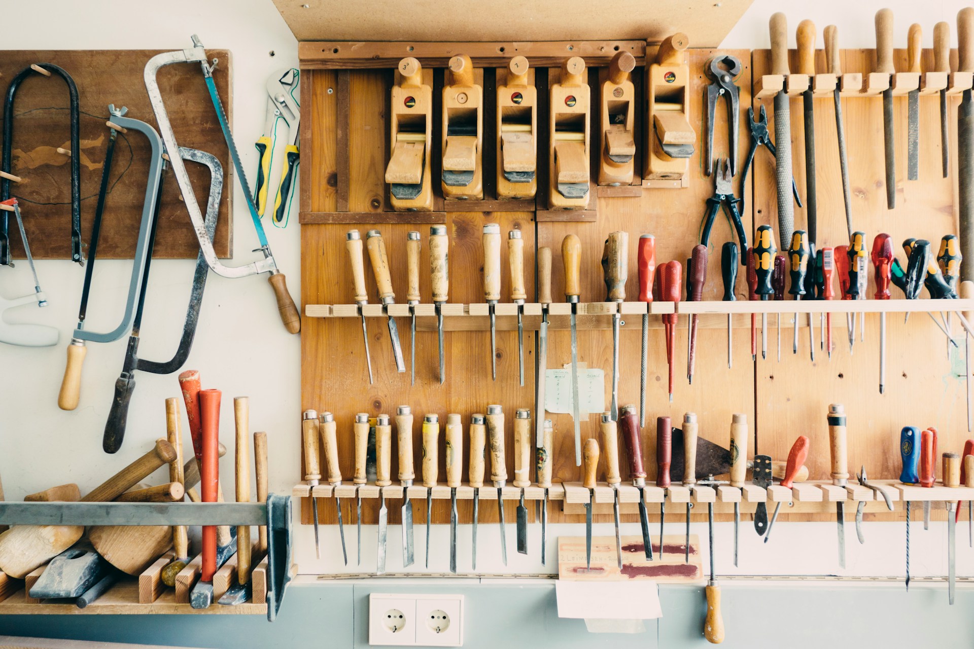 Woodworking tools hung on workshop wall