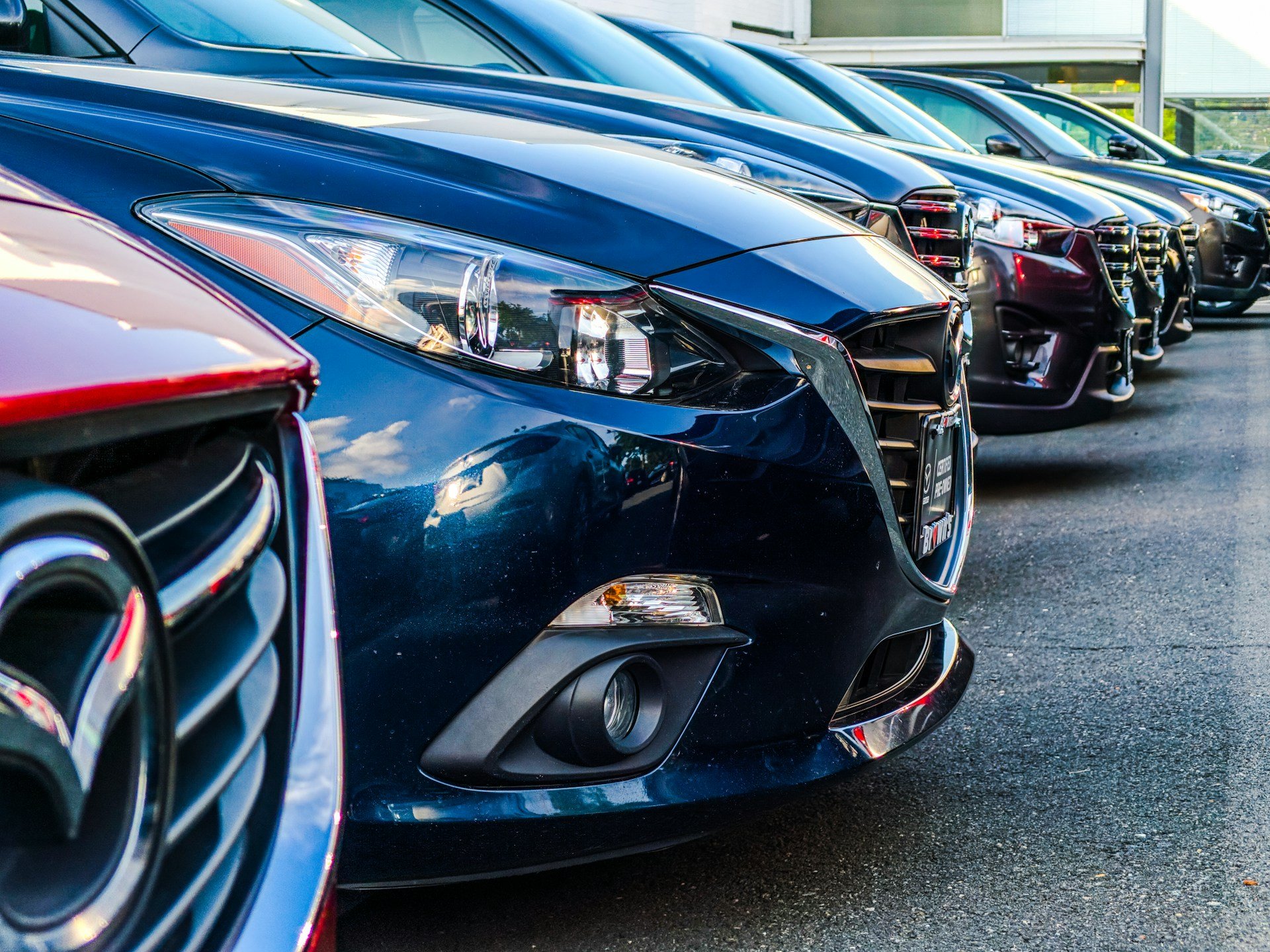 Row of parked vehicles at a car dealership