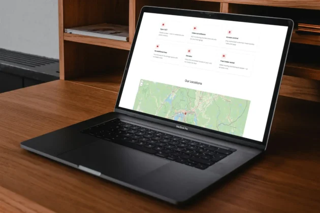 Laptop displaying a self storage website with service features and location map on a desk