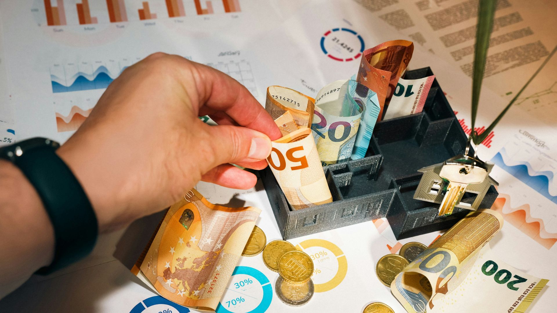 A man placing currency notes over a cost chart