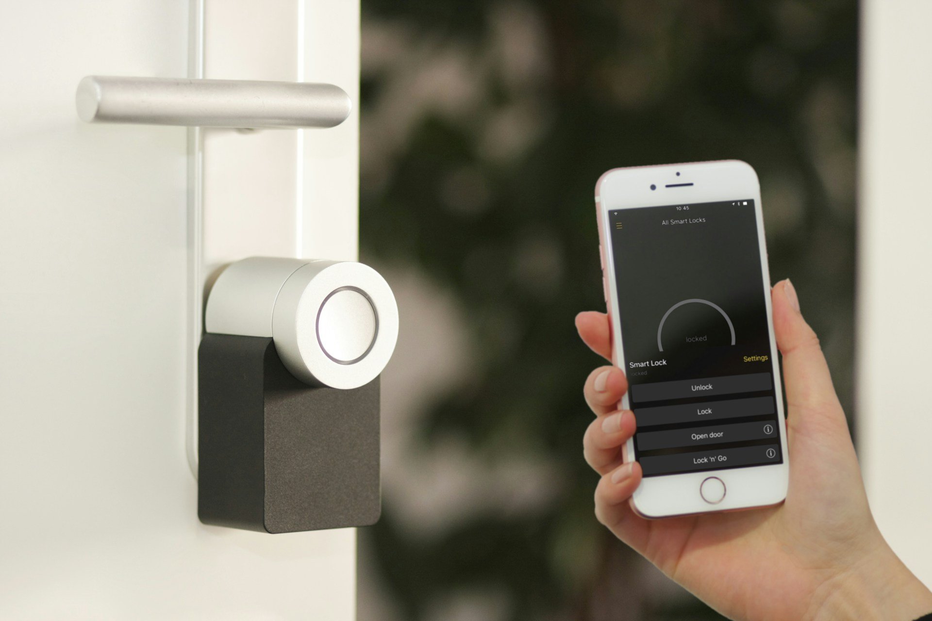 Hand using a smartphone app to control a smart door lock.