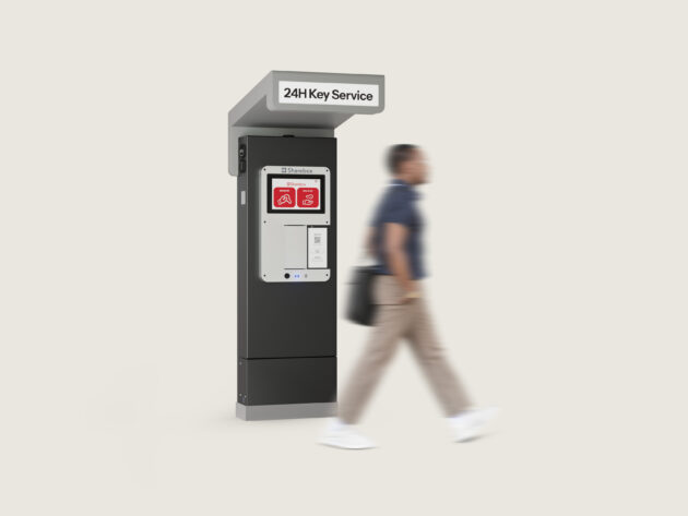 Person walking past a self-service 24-hour key kiosk